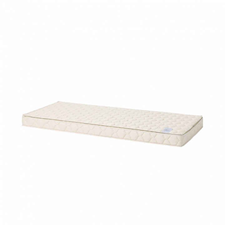 Bed mattress with quilted pattern in beige color and smooth surface.